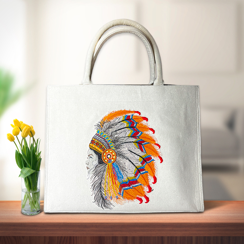 A finished personalized tote bag featuring a vibrant, detailed embroidered design of a tribal headgear, representing the final product from Dhaga-Raga’s embroidery finishing process